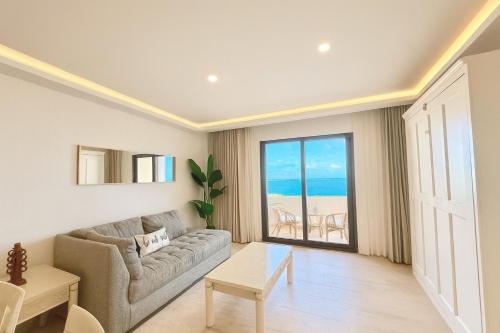 a living room with a couch and a large window at Oceanfront Paradise in Cancun Hotel Zone in Cancún