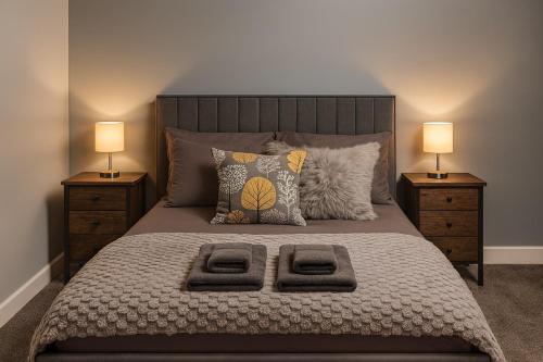 a bedroom with a large bed with two night stands at Harbour Lights Retreat-Small and Cosy 1 bedroom in Ferryden