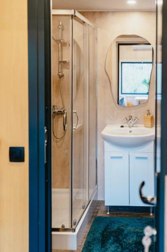 a bathroom with a shower and a sink at Dreambox South Kerry in Sneem