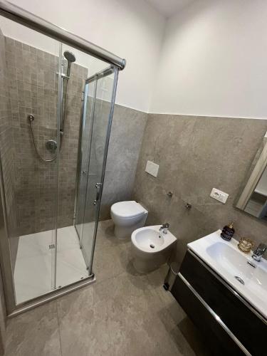 a bathroom with a shower and a toilet and a sink at G&Ghomeciampinosuite in Ciampino