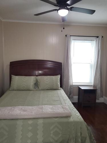 a bedroom with a bed with a ceiling fan at Apt 1 Stylish First Floor Apartment in Worcester