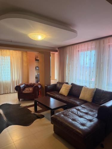 a living room with a couch and a table at Ava Apartment Pamporovo in Pamporovo