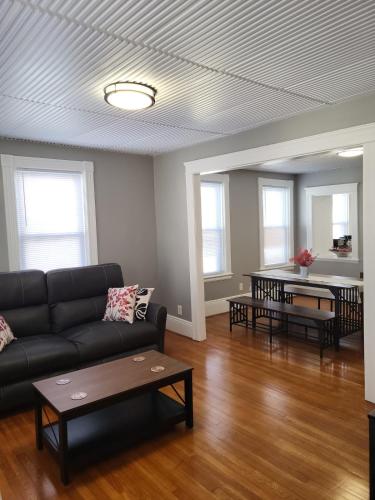 a living room with a couch and a table at Apt 2 2nd Floor in the Heart of the City in Worcester