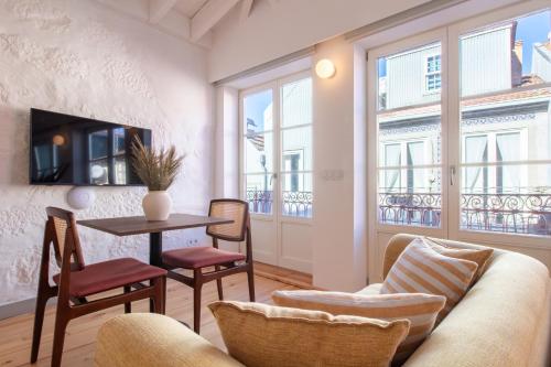 a living room with a couch and a table at Bainharia 82 by LovelyStay in Porto