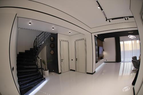 a hallway with a staircase in a house at Davos Hotel in Pʼarakʼar