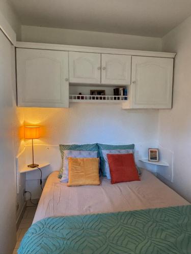 a bed with two pillows on it in a room at SeaNest Le Nid Marin in Saint-Raphaël