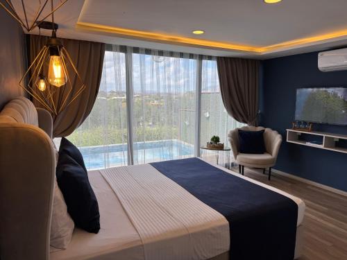 a bedroom with a large bed and a large window at majestic tiny home with private pool in Trikomo