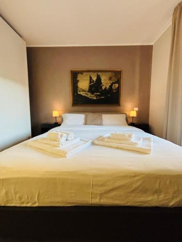a bedroom with a bed with two towels on it at Ales apartment in Cuneo