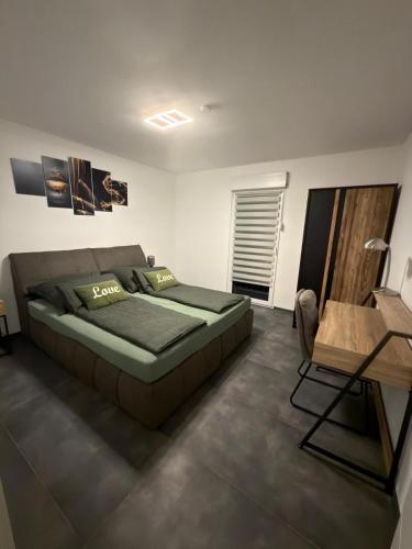 a bedroom with a bed and a table in it at Mira Suites 2 in Schwalbach