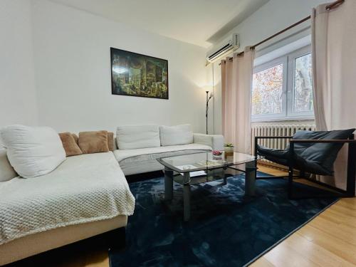 a living room with a couch and a table at Black and Ginger Residence in Zrenjanin