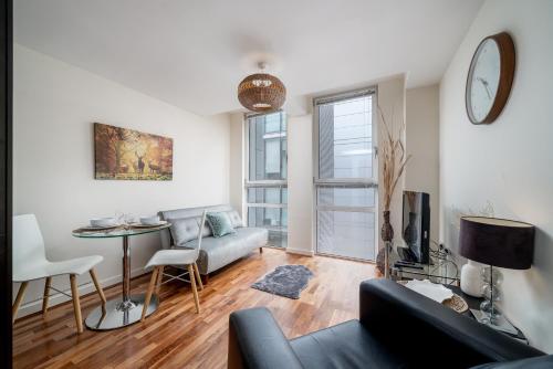 a living room with a couch and a table at London Central 1 bed deluxe-Moorgate in London