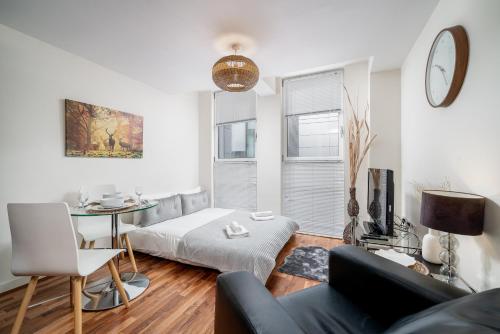 a living room with a couch and a table at London Central 1 bed deluxe-Moorgate in London