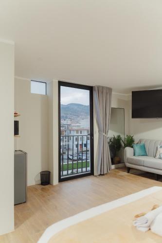a living room with a couch and a large window at Estancia del Alba in Cajamarca