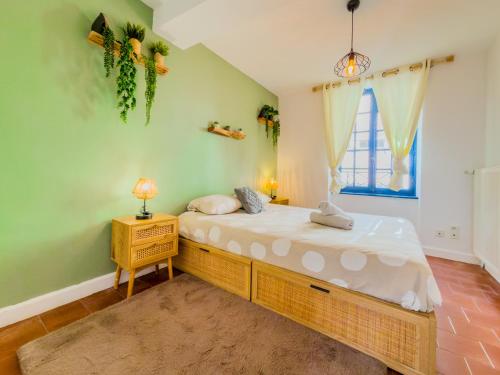 a bedroom with a bed with a night stand and a window at Le Patio ※ Carnot in Carcassonne