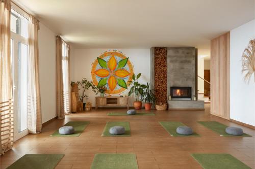 a room with a bunch of yoga mats on the floor at Yeotown Madeira Wellness Hotel and Nature Stay in Arco da Calheta
