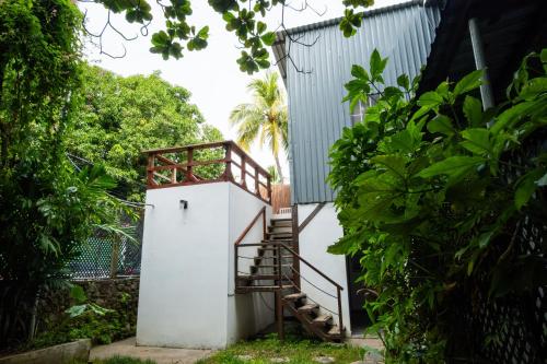 a stairway leading up to a small white building at Hotel Michanti in El Zonte