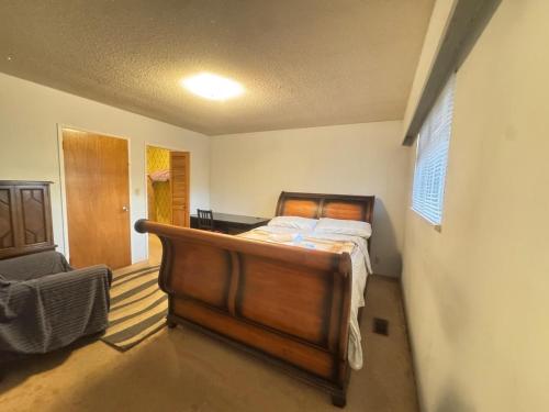 a bedroom with a bed and a chair at Richmond 6011 in Richmond