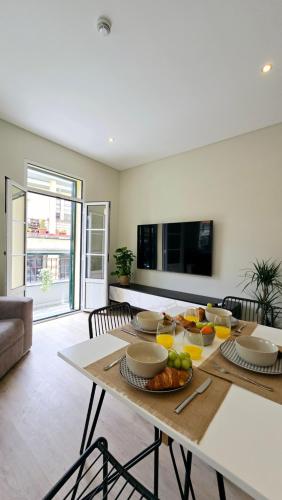 a living room with a table with food on it at In City - Funchal Heart with Rooftop in Funchal