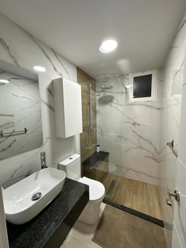 a bathroom with a sink and a toilet and a shower at Apartamento Studio Anau k&L- Playa del inglés - Yumbo in Playa del Ingles