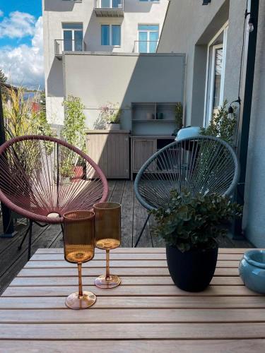 a patio with two chairs and a table with candles at NØDA - Nørdic Design Apartment with Terrace in Liptovský Mikuláš