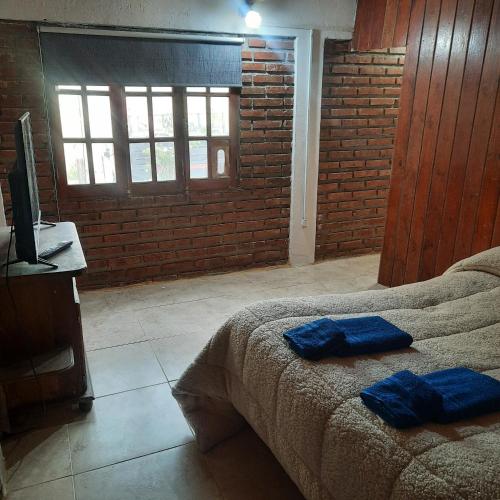 una camera da letto con un letto con asciugamani blu sopra di dpto MDZ a Comodoro Rivadavia