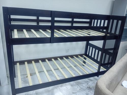 a black bunk bed in a room at AG DORMS and BUNKS in Doha