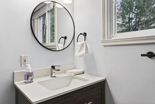 a bathroom with a sink and a mirror at Abby's Place in Fredericton