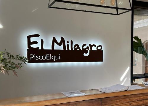 a sign on the wall of a store at Hotel El Milagro in Pisco Elqui