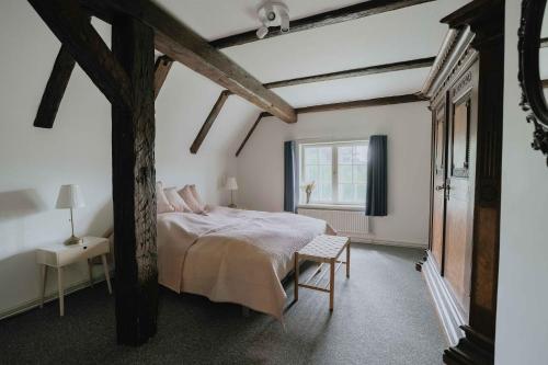 a bedroom with a large bed and a window at Hindemae Estate For Holidays And Events in Ullerslev