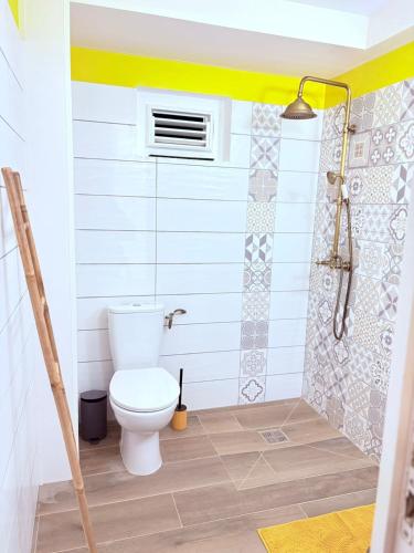 a bathroom with a toilet and a shower at Le Ti Marinois 6 in Le Marin