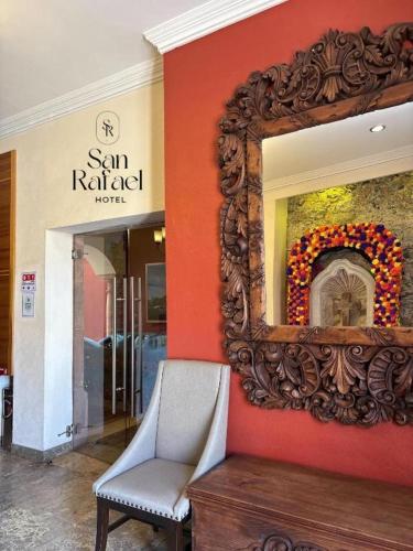 a mirror on a wall with a chair in a store at Hotel San Rafael in Querétaro