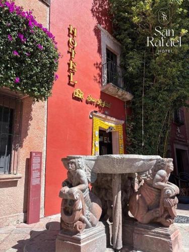 a stone fountain in front of a building at Hotel San Rafael in Querétaro