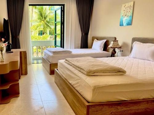Postel nebo postele na pokoji v ubytování Minh Anh Hotel