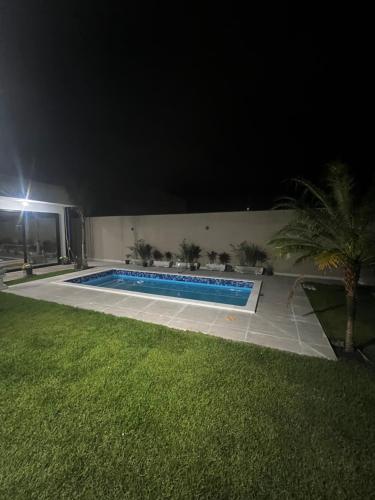 a swimming pool in a yard at night at Enseada Beach in São Sebastião