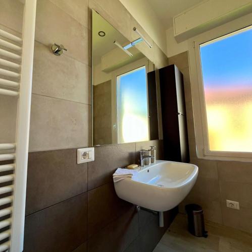 a bathroom with a sink and a mirror at La vista Azzurra in Bordighera