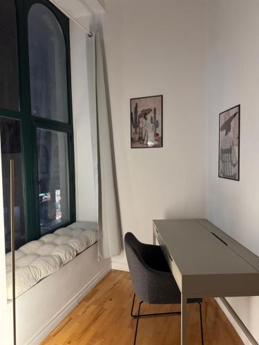 a desk and a chair in a room with a window at Top Location - The 777 Old Port Gem in Montréal