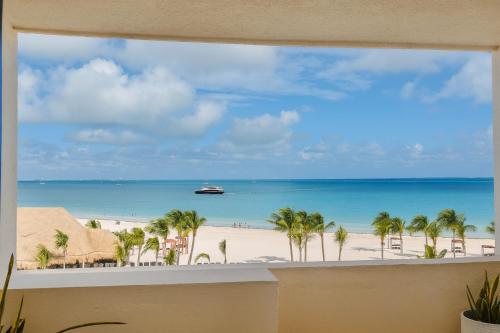 a view of the beach from a balcony at Oceanfront Paradise in Cancun Hotel Zone in Cancún