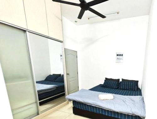 a bedroom with two beds and a mirror at PORT DICKSON HomeStay, Family 2 BR Netflix Wifi in Port Dickson