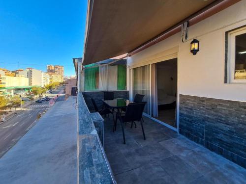 a balcony with a table and chairs on a building at Apartalux Ático Jaime I in Benidorm