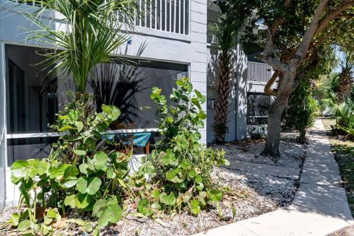 a house with plants in front of a building at 1BR Cocoa Beach Home - 1 Min to Beach in Cape Canaveral