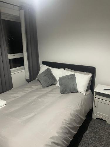 a bed with two pillows on it with a window at Bridgewater Court 2 in Southampton