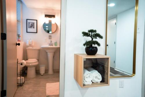 a bathroom with a toilet and a plant on a shelf at Hidden Escape Atlanta Near BENZ ARPT Beltline in Atlanta