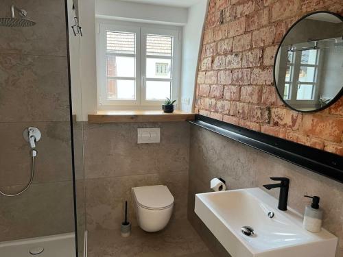a bathroom with a sink and a toilet and a mirror at Holiday home in Ahorntal with swimming pool in Hinterkleebach