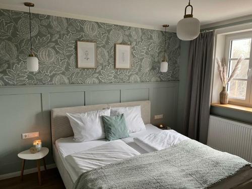 a bedroom with a bed with white sheets and pillows at Holiday home in Ahorntal with swimming pool in Hinterkleebach