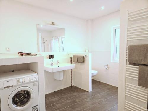 Hallenbach with Moselle view في زيل ان دير موسل: حمام ابيض مع غسالة ومغسلة