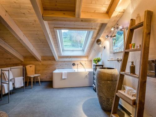 a bathroom with a large tub and a window at Holiday apartment with 1 bedroom in Sigiswang