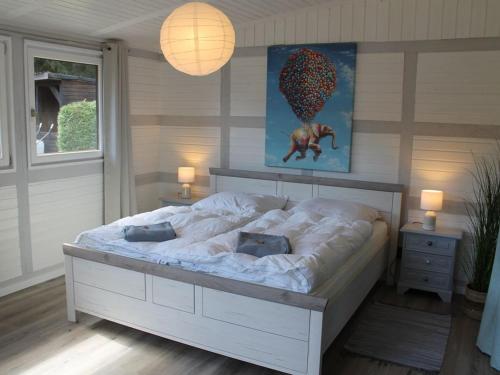 Un dormitorio con una gran cama blanca en una habitación. en Holiday home Heide, en Bad Bodenteich