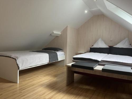 a bedroom with two beds in a attic at Holiday apartment Ina in Sankt Aldegund