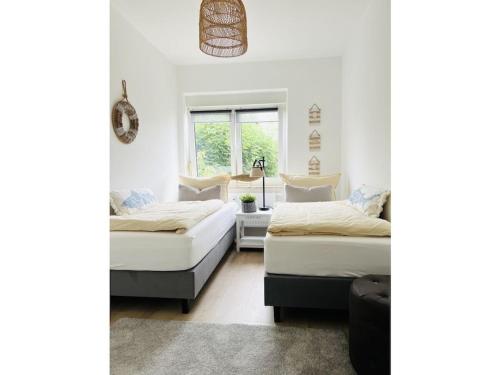 En eller flere senge i et værelse på Wattnflair Lütje Kaap