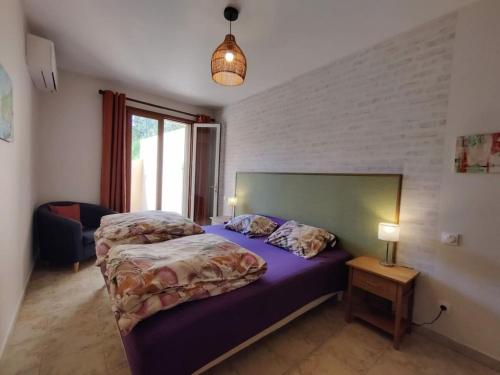 a bedroom with two beds and a table with a lamp at Holiday apartment in Lumio with swimming pool in Lumio